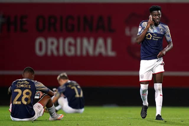 GREATEST ESCAPE: Clarke Oduor on the phone after saving Barnsley from relegation at Brentford's Griffin Park in July 2020