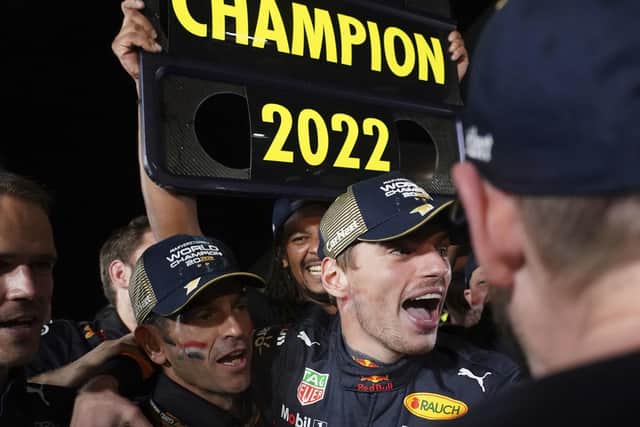 Red Bull driver Max Verstappen, center, of the Netherlands celebrates with teammates as he became F1 drivers world champion, during the Japanese Formula One Grand Prix at the Suzuka Circuit in Suzuka. (AP Photo/Toru Hanai)