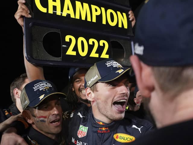 Red Bull driver Max Verstappen, center, of the Netherlands celebrates with teammates as he became F1 drivers world champion, during the Japanese Formula One Grand Prix at the Suzuka Circuit in Suzuka. (AP Photo/Toru Hanai)