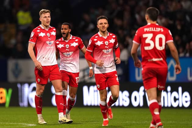 Barnsley's Sam Cosgrove (left) celebrates scoring the Reds' third goal of the game during the Sky Bet League One play-off semi-final, second leg at Bolton. Picture: Martin Rickett/PA Wire.