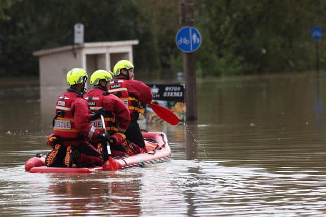 Crews from South Yorkshire Fire and Rescue helping people in Catcliffe by boat following severe flooding earlier this year.