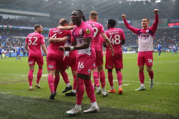 PARTY TIME: Huddersfield Town’s Matthew Pearson celebrates with team-mates after an own goal by Cardiff City’s Jack Simpson in South Wales on Sunday. Picture: Nigel French/PA