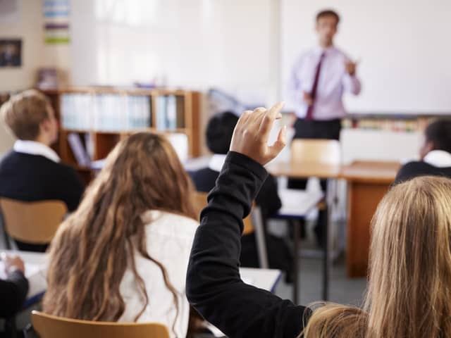 ADOBE STOCK
Female Student Raising Hand To Ask Question In Classroom