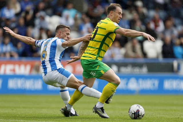 BATTLE: Huddersfield Town's Jonathan Hogg challenges Ashley Barnes of Norwich City