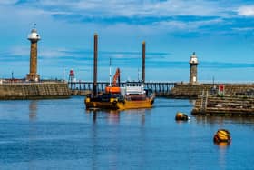The dredger Sandsend approaches Whitby Harbour