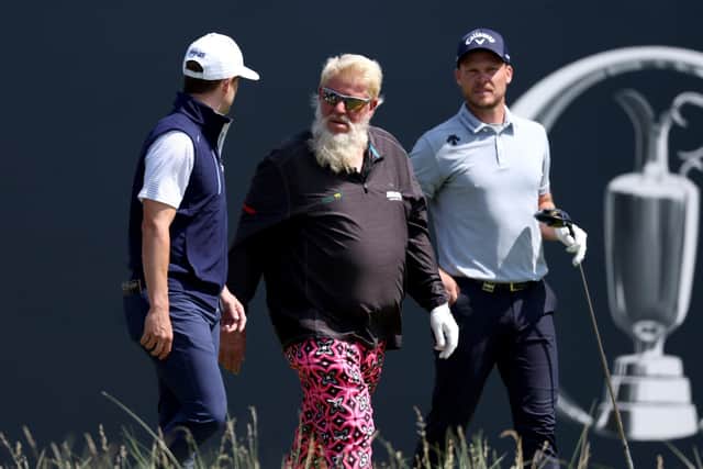 Colourful: Danny Willett of England, John Daly of the United States and Taylor Moore of the United States walk off the 1st tee (Picture: Gregory Shamus/Getty Images)