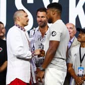 JEDDAH, SAUDI ARABIA - AUGUST 19: Oleksandr Usyk (L) and Anthony Joshua (R) shake hands as Eddie Hearn, Boxing promoter of Matchroom boxing and Robert Garcia, head coach of Anthony Joshua look on during the Weigh-In for Oleksandr Usyk v Anthony Joshua Rage on the Red Sea event at King Abdullah Sports City Arena on August 19, 2022 in Jeddah, Saudi Arabia. (Photo by Francois Nel/Getty Images)