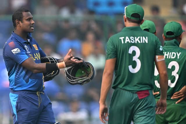 Angelo Mathews protests in vain to the Bangladesh players, brandishing his damaged helmet after he was given timed out. Photo by Arun Sankar/AFP via Getty Images.