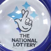 Outgoing UK National Lottery operator Camelot has revealed falling sales of tickets and instant win games as it flagged signs that players had "tightened their belts" in the face of soaring living costs.