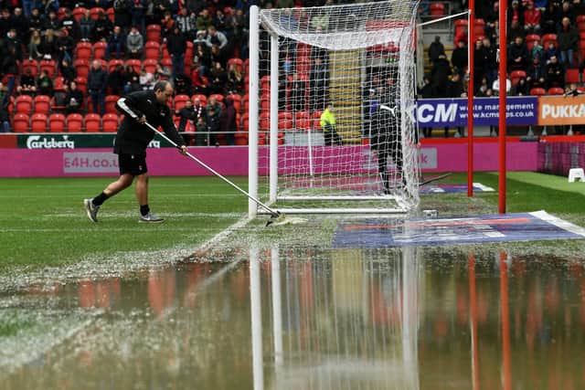 Rotherham United v Cardiff City. Groundstaff clear rain water off the pitch. Picture: Jonathan Gawthorpe