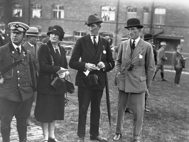 Mr and Mrs Hartigan and Mr GF Hartigan at the Pontefract Races in Yorkshire, standing with an RAC driver in September 1926.