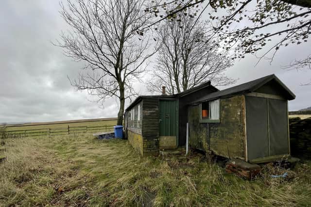 1930's dilapidated hut with a hole in the roof and no running water or electricity perched on rough terrain in the Peak District sold for £124,000 at auction. Auction House South Yorkshire / SWNS
