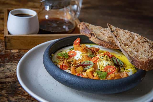 Poached eggs on a bed of Tamper kitchen, strained yoghurt with sweet roasted squash, pickled chilli and  hazelnut dukkhah butter, served with toasted malt sourdough alongside a V6 hand brew coffee. 
Picture: Tony Johnson
