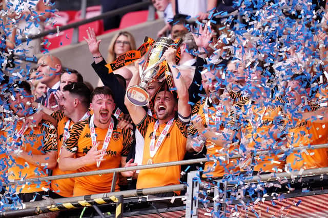 WINNERS: Hull City's Lewis Coyle lifts the trophy (Image: Adam Davy/PA Wire)