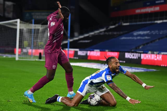FEELING THE PAIN: Huddersfield Town's Sorba Thomas goes down with Jamilu Collins at his back