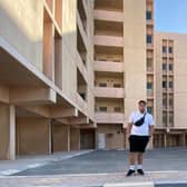 Rob Dawley in front of the abandoned apartments in Qatar.