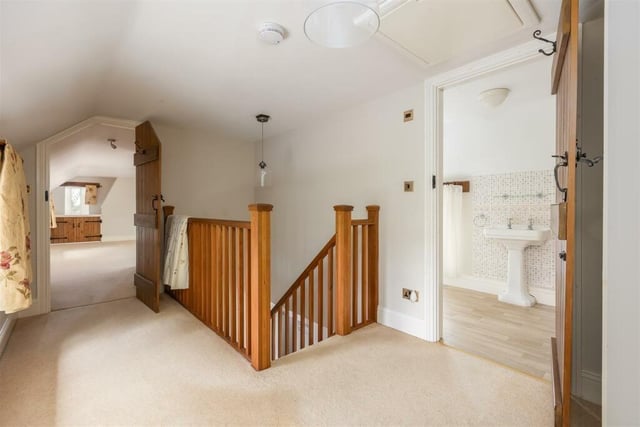 The upper floor of the property with wood staircase and a spacious landing
