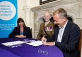 Skipton Group CEO Stuart Haire, Skipton Building Society chair Gwyn Burr and Lieutenant Colonel Richard Hill signing the Armed Forces Covenant at Skipton Castle.