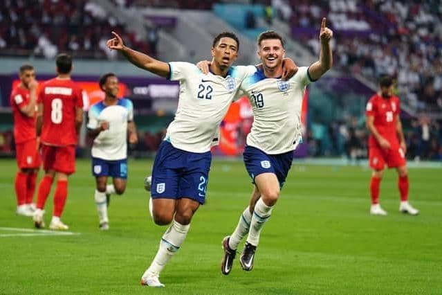 England's Jude Bellingham celebrates scoring his side's opening goal of the game against Iran with team-mate Mason Mount during the World Cup Group B match at the Khalifa International Stadium. Picture: Mike Egerton/PA