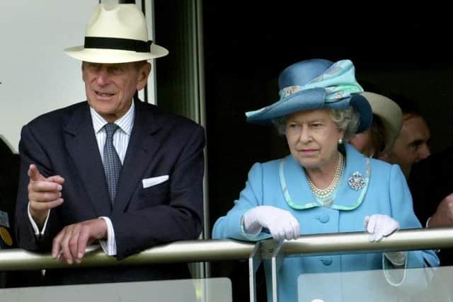 The Queen and the Duke of Edinburgh watch from the balcony of the weighing room as horses parade for the Champagne Victor Queen's Golden Jubilee Handicap Stakes at Beverley in 2002. Picture: Terry Carrott