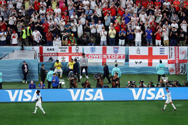 England forwards Bukayo Saka and Phil Foden are applauded by supporters as they leave the pitch during the Qatar 2022 World Cup round of 16 football match between England and Senegal at the Al-Bayt Stadium in Al Khor - with a Middlesbrough flag also pictured!