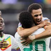 Senegal's forward #20 Bamba Dieng (centre left) celebrates with teammates after scoring his team's third goal during the Qatar 2022 World Cup Group A football match between Qatar and Senegal at the Al-Thumama Stadium in Doha on November 25, 2022. (Photo by KARIM JAAFAR / AFP) (Photo by KARIM JAAFAR/AFP via Getty Images)