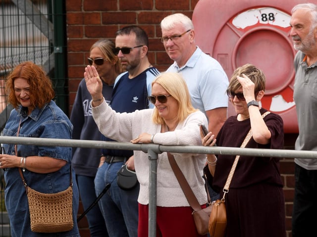 Spectators line the dockside, waving to the flotilla as it passes through the heart of Goole during the bicentenary event