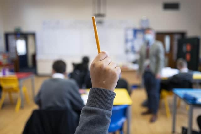 A pupil raises their hand at school. (Pic credit: Matthew Horwood / Getty Images)