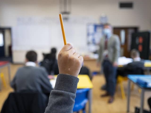 A pupil raises their hand at school. (Pic credit: Matthew Horwood / Getty Images)