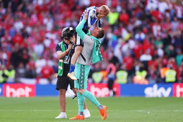 YOU BEAUTY: David Stockdale hoists Sheffield Wednesday captain and midfielder Barry Bannan aloft after their team's dramatic League One Play-off Final victory over Barnsley at Wembley. after the team's victory Picture: Richard Heathcote/Getty Images