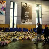 REMEMBERED: Fans look at floral tributes outside the Motorpoint Arena, Nottingham, ahead of a memorial for Nottingham Panthers' ice hockey player Adam Johnson, the 29-year-old who died after a 'freak accident' during a Challenge Cup match against Sheffield Steelers on October 28. Picture: Zac Goodwin/PA