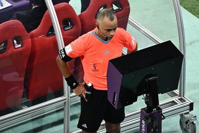 Brazilian referee Wilton Sampaio consults the pitch-side VAR monitor before giving a penalty to England (Picture: JEWEL SAMAD/AFP via Getty Images)