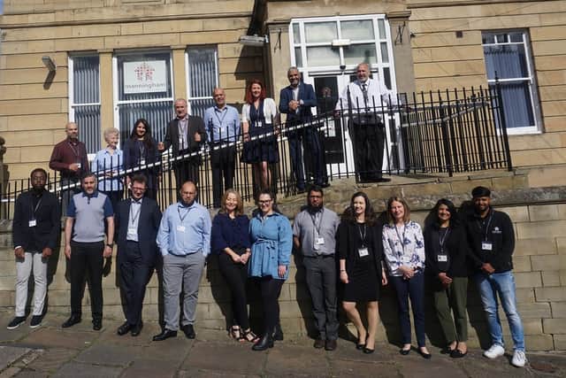 Manningham Housing Association employees stand outside the Bradford headquarters. The organisation  has become the first housing association in the world to achieve the global standard for diversity and inclusion in HR management.