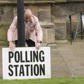 A polling station sign is adjusted oustide the polling station in Bridlington Priory Church, Yorkshire. PIC: Danny Lawson/PA Wire