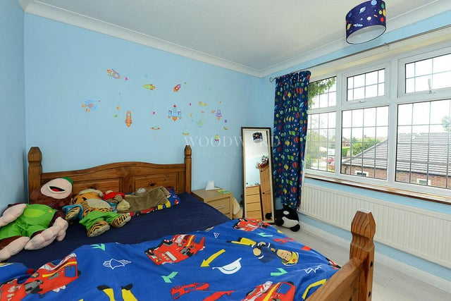 This is one of the other two bedrooms, clearly ideal for a young child.  It has laminated wood flooring, a radiator and a double-glazed window overlooking the back of the house. Out of shot, there is also a range of fitted wardrobes.