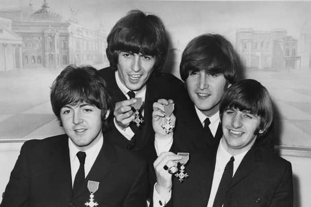 The Beatles hold a press reception at the Saville Theatre in London after each received an MBE at Buckingham Palace in October 1965. From left to right, Paul McCartney, George Harrison, John Lennon, Ringo Starr. (Photo by Central Press/Hulton Archive/Getty Images).