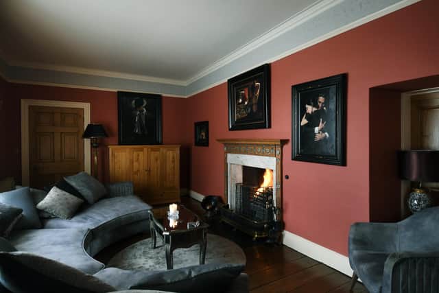The cosy sitting room with Georgian fireplace and picture by Fabian Perez