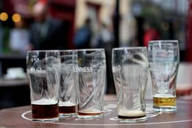 Empty pint glasses outside a bar. PIC: Brian Lawless/PA Wire