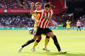 SHEFFIELD, ENGLAND - AUGUST 06: Anel Ahmedhodzic of Sheffield United is challenged by Mason Bennett of Millwall during the Sky Bet Championship match between Sheffield United and Millwall at Bramall Lane on August 06, 2022 in Sheffield, England. (Photo by Cameron Smith/Getty Images)