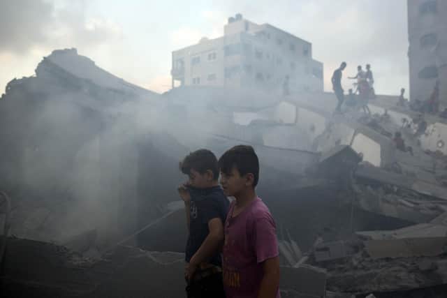 Palestinians inspect a damaged building after it was hit bombed by an Israeli airstrike in Gaza City in 2018. PIC: AP Photo/Khalil Hamra