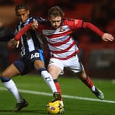 Up against it: Doncaster Rovers' James Maxwell (right) battles with Stockport County's Che Gardner during Tuesday night's comfortable win for the visitors at the Eco-Power Stadium. (Picture: Jonathan Gawthorpe)