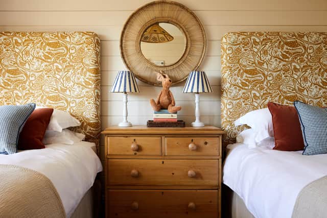The twin bedroom with Mark Hearld fabric covered headboards