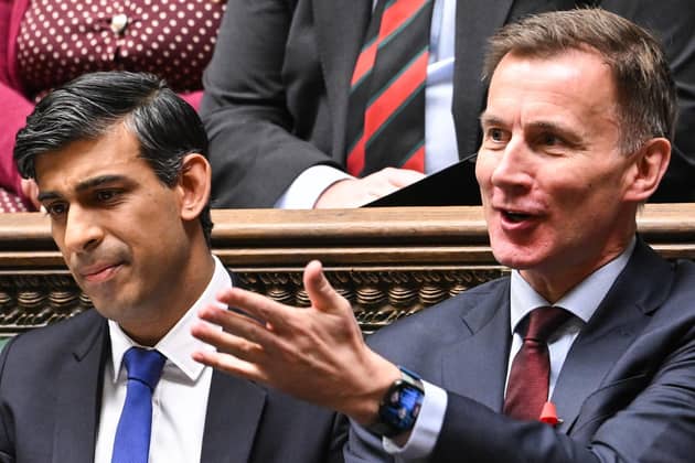 Prime Minister Rishi Sunak (L) and Britain's Chancellor of the Exchequer Jeremy Hunt (R) reacting during Prime Minister's Questions (PMQs), in the House of Commons