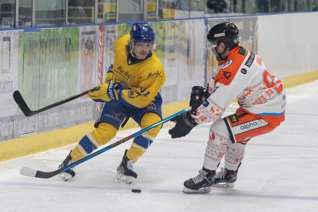 FORCE OF NATURE: Leeds Knights' Oliver Endicott competes with Sheffield Steeldogs' Jonathan Kirk in the NEw Year's Eve derby in Sheffield. Picture: Tony Johnson.
