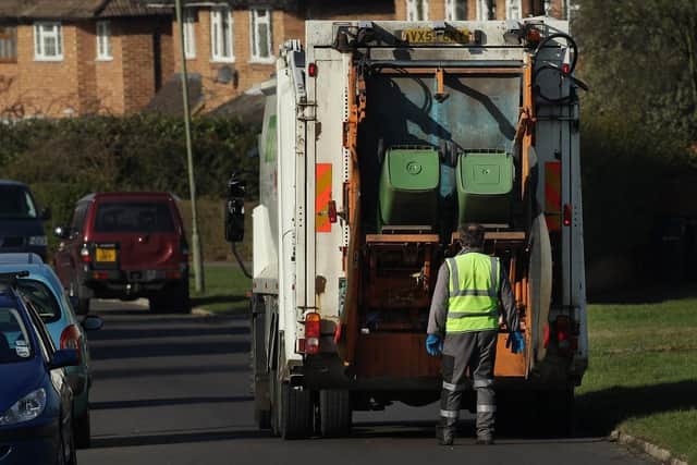 Refuse collectors empty green 'wheelie' bins.  (Pic credit: Peter Macdiarmid / Getty Images)