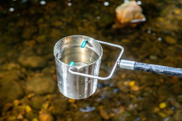 Water samples being taken from a river. PIC: James Hardisty