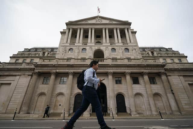 A man walks past the Bank of England in the city of London after sterling hit its lowest level against the dollar since decimalisation in 1971. The pound fell by more than 4 percent to just 1.03 dollars in early Asia trading before rebounding to 1.09 dollars on Monday afternoon as speculation mounted over an intervention by the Bank of England, with officials there understood to be considering making an emergency statement this afternoon. Picture date: Monday September 26, 2022. PA Photo. See PA story POLITICS BUdget. Photo credit should read: Yui Mok/PA Wire