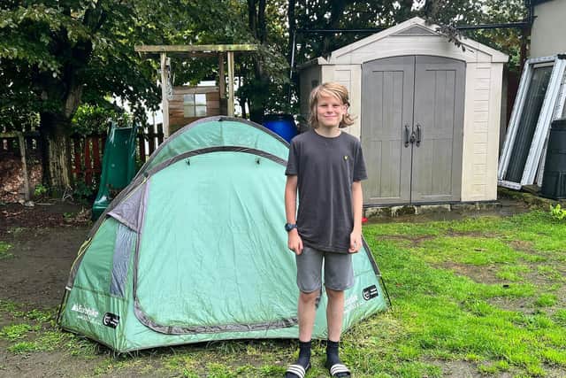 Billy Thompson, 13, from Pudsey, West Yorkshire, who has surpassed a year of camping in his garden in the heavy snow and rain. Photo credit: Simon Thompson/PA Wire