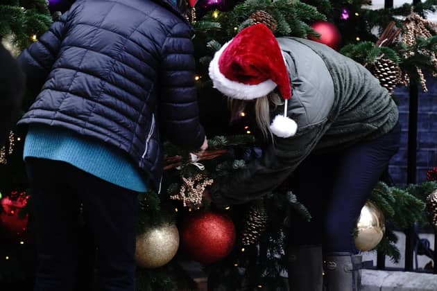 Decorators put the finishing touches to the ornaments on the Christmas tree outside 10 Downing Street. PIC: Aaron Chown/PA Wire
