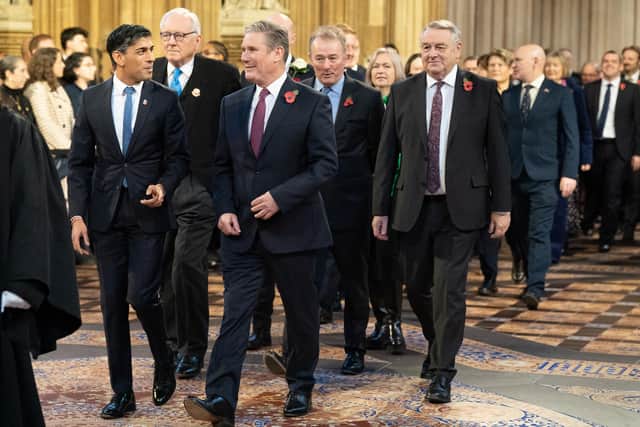 Prime Minister Rishi Sunak (left) walks with Labour Party leader Sir Keir Starmer through the Central Lobby at the Palace of Westminster ahead of the State Opening of Parliament. PIC: Stefan Rousseau/PA Wire